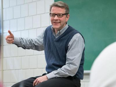 Male faculty member in front of the classroom.